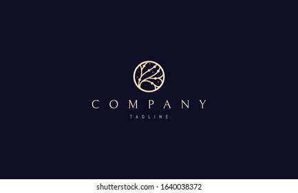 Vector golden logo on which an abstract image of a tree in the center of the circle.