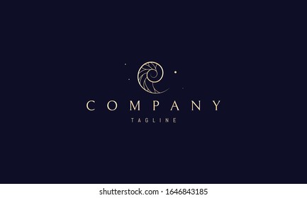 A vector golden logo on which an abstract image of a beautiful seashell in a section.