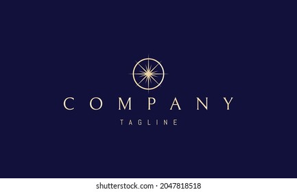 Vector golden logo on which an abstract image of a bright star in a circle in the form of a compass.