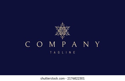 Vector golden logo on which an abstract image of a snowflake in the form of a sophisticated flower.