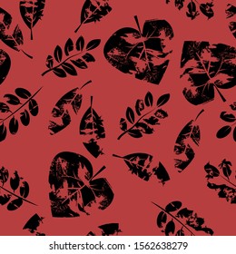 The vector graphic. Seamless pattern. The black leafs on the red background. EPS10