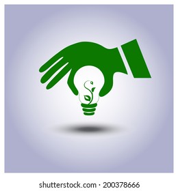 Vector green ecology light bulb icon in hand