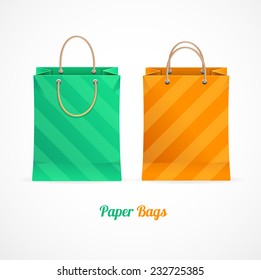 Vector green and orange paper shopping bags isolated on white