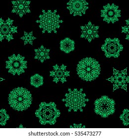 Vector green snowflakes on black background. Abstract minimal seamless pattern background.