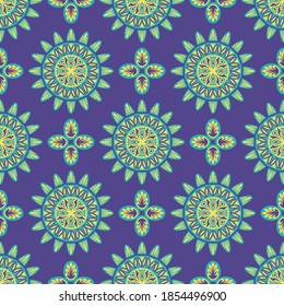 vector green and yellow ethnic mandala seamless pattern on violet
