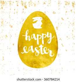 Vector greeting card. Gold foil egg sticker. Calligraphy lettering Happy easter with a rabbit