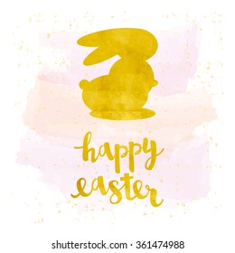 Vector greeting card. Gold foil calligraphy lettering Happy Easter with silhouette of a rabbit
