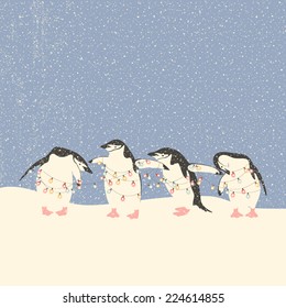 Vector greeting card with penguins holding string of Christmas lights