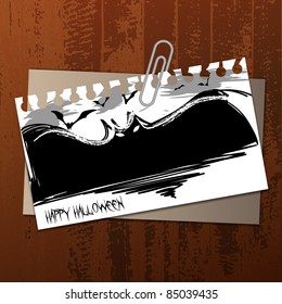 Vector Halloween Label Concept on Wooden Surface - Flying Bats Drawn To a Torn Notepaper, Clipped to an Envelope 