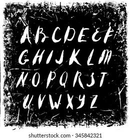 Vector hand drawn alphabet isolated on black grunge retro background texture.