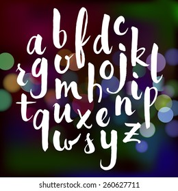 Vector hand drawn alphabet on bokeh light background. Brush painted letters.Vector illustration.