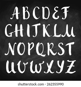 Vector hand drawn alphabet on chalkboard. Brush painted capital letters. Rough contour.