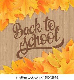 vector hand drawn back to school lettering with realistic maple leafs and greetings label on wooden background. Can be used as card or poster.