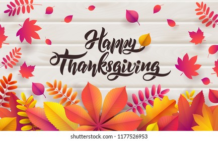 Vector Hand drawn Happy Thanksgiving typography poster. Celebration quotation for greeting card. Vector vintage style autumn calligraphy. Lettering text Thanksgiving, fallen leaves on wood background