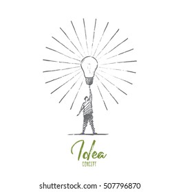 Vector hand drawn Idea concept sketch. Man standing and touching big shining bright light bulb on raised hand meaning getting great idea. Lettering Idea concept