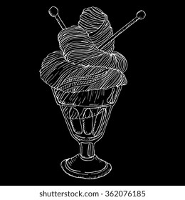 Vector hand drawn illustration of skein yarn with needles in ice-cream cup chalk on black background