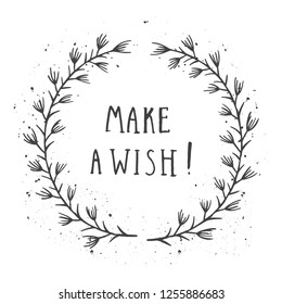 Vector hand drawn illustration of text MAKE A WISH! And floral round frame with grunge ink texture on white background. Monochrome.