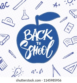 Vector hand drawn lettering of Back to School with apple and doodles supplies on sheet of exercise book background