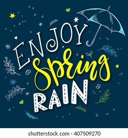 vector hand drawn lettering quote - enjoy spring rain. With decorative branches, flowers drops and open umbrella.