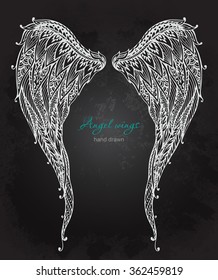 Vector hand drawn ornate angel wings, zentangle style. Doodle black and white illustration on grunge background