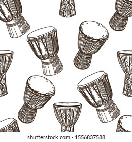 Vector hand drawn seamless pattern of African drums in the style of engraving on white background.