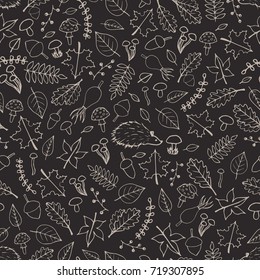 Vector hand drawn seamless pattern with autumn elements contours: foliage, berries, acorns, mushrooms, oak and maple leaves, rose hips and hedgehogs on the gray background. Cute fall ornament.