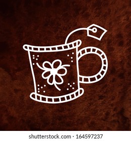 Vector hand drawn tea cup with floral ornament and teabag. Vector design element on textured paper. Can be used for web and printing.
