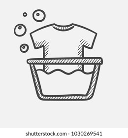Vector hand drawn T-shirt in basin with foam outline doodle icon. Handwash sketch illustration for print, web, mobile and infographics isolated on white background.