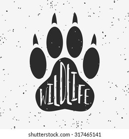 Vector hand drawn typographic poster with a Wolf Paw. Wildlife. Grunge texture. T-shirt design, label, decor elements, greeting and postal cards. Eco hipster style illustration