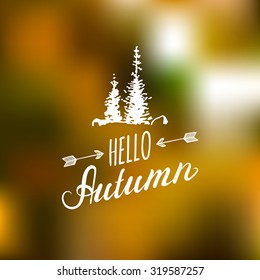 Vector hand lettering inspirational typography poster Hello autumn with spruces silhouettes on blurred background