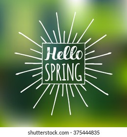 Vector hand lettering inspirational typography poster Hello spring on blur background. Fun quote design logo or label.