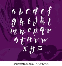 Vector hand written brush pen script. Hand drawn calligraphic latin alphabet. Cute isolated letters on an abstract background.