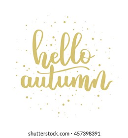 Vector hand written lettering quote. Modern calligraphy phrase. Hello autumn. Gold ink on white isolated background with dots.