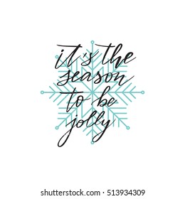 Vector hand written winter phrase - It's the season to be jolly. Black calligraphy poster isolated on white background with blue snowflake. Great print for your design