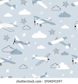 Vector hand-drawn seamless repeating children simple pattern with aircraft, stars and clouds in Scandinavian style on a blue background.Kids seamless pattern with planes. Funny airplanes.