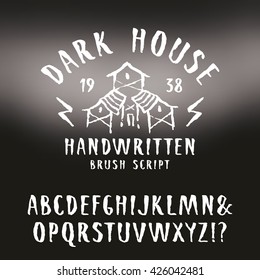 Vector handwritten brush font in horror style. White print on blurred background