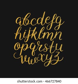 Vector handwritten brush script with gold glitter, shine alphabet on black background. Hand drawn letters