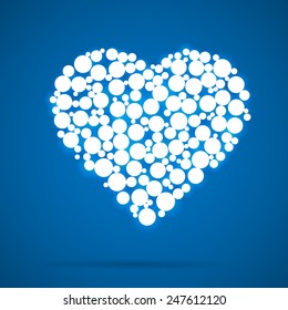 Vector heart made of glowing circles on a blue background