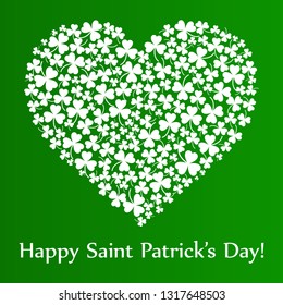 vector heart made of small shamrocks on green background