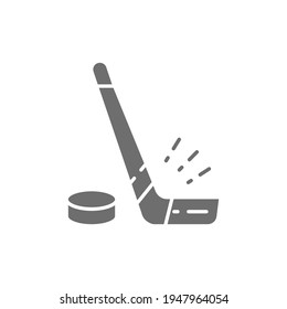 Vector hockey stick and puck gray icon.