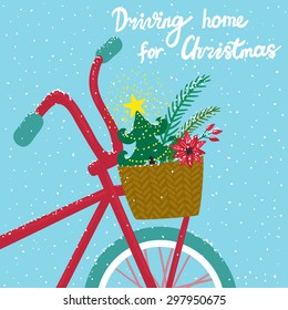 Vector holiday card with red bicycle, christmas tree in basket, snow and hand written text "Driving home for Christmas". Beautiful winter background. 