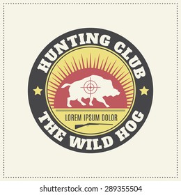 Vector hunting club emblem with a wild hog silhouette.  Desaturated vintage colors (red, yellow, black).