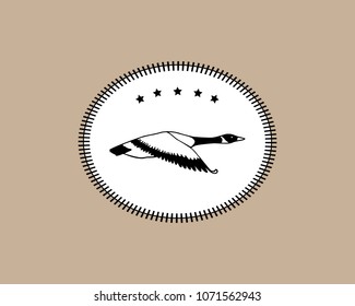 Vector hunting emblem with hand drawn flying wild goose. Beautiful animal design elements, ink drawing.