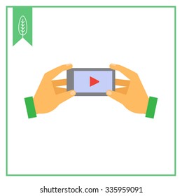 Vector icon of human hands holding smartphone with media player sign