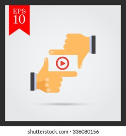 Vector icon of media player sign between human fingers