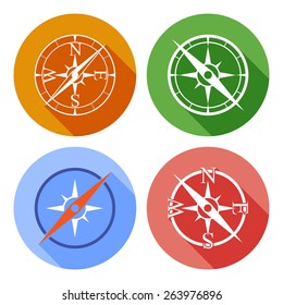 Vector icons depicting four different compasses on a color circle buttons