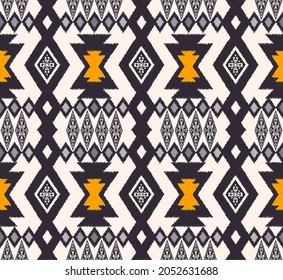 Vector ikat native aztec tribal rhombus geometric shape seamless background. Ethnic yellow-blue grey color pattern design. Use for fabric, textile, interior decoration elements, upholstery, wrapping.