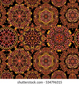 Vector illustration. Arab, Asian, ottoman motifs in yellow, red and orange colors. Seamless pattern on black background. Simple snowflakes seamless pattern, floral elements, decorative ornament.
