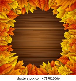 Vector illustration of Autumn leaves frame on wooden background
