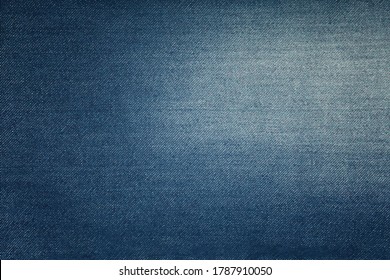 Vector illustration background texture of dark indigo blue cotton jeans denim with light washed distressed faded area